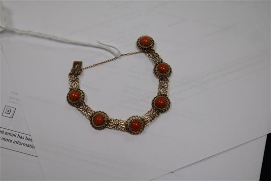 A 9ct gold and cabochon coral set pierced bracelet.